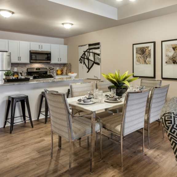 a dining room with a table set for four.