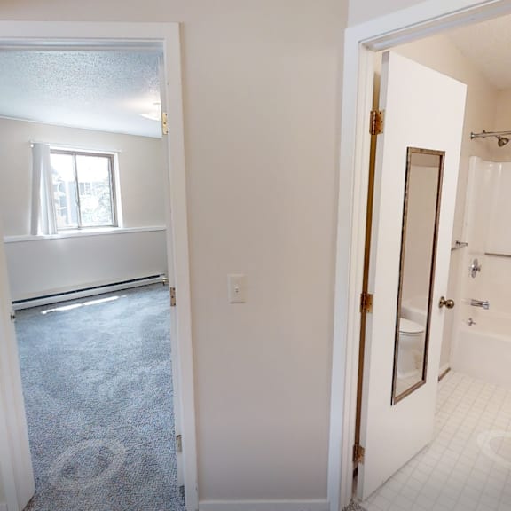 a bathroom with a toilet, sink, and shower.