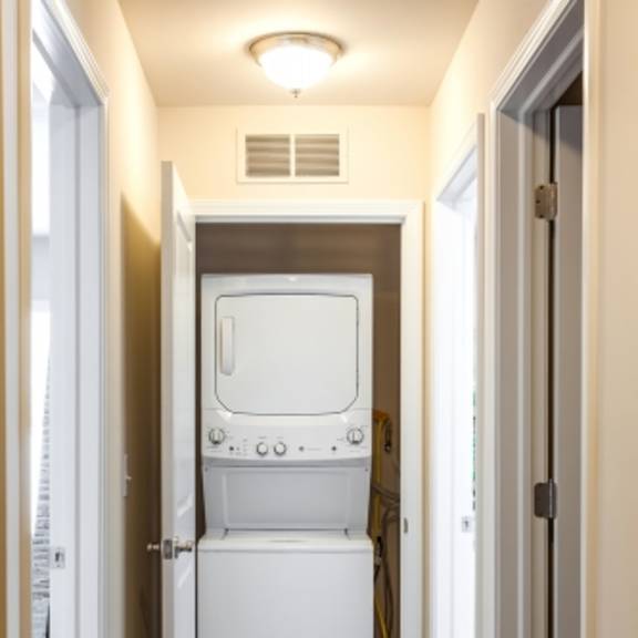 a white oven and fridge in a narrow hallway.