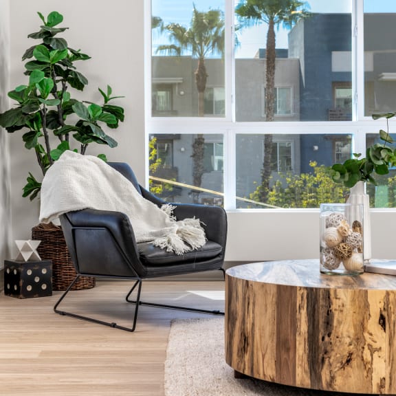 a living room with a chair and a coffee table