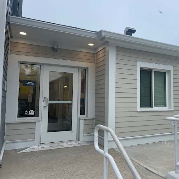 a home with a front door and a ramp to a porch
