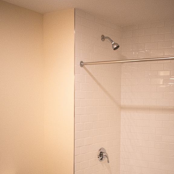 a bathroom with a toilet and a tub and a shower
