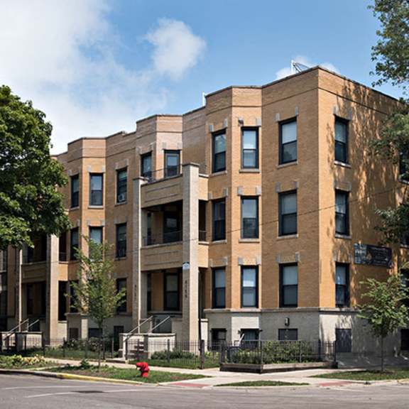a large brick building on the corner of a street