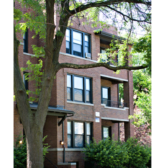 a large brick building with trees in front of it