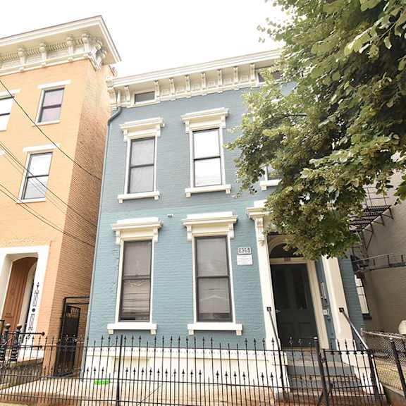 a blue house and a yellow house are next to each other