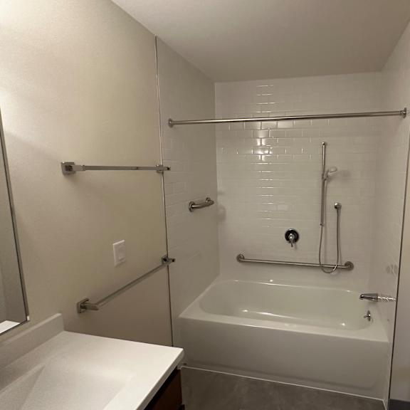 a small bathroom with a shower and a sink