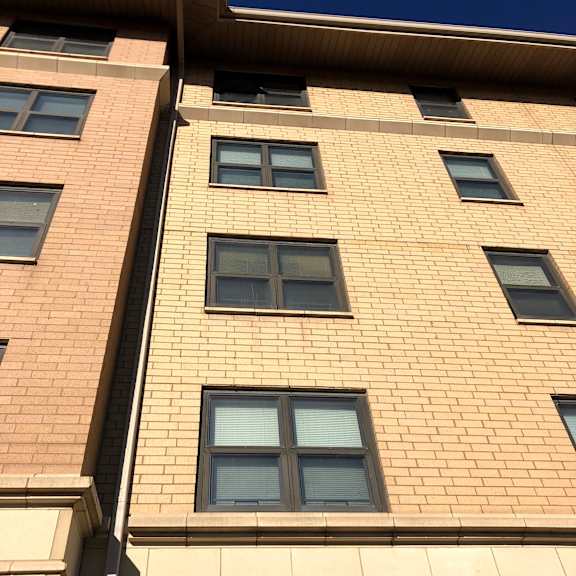 a tall building with many windows is shown in the image.