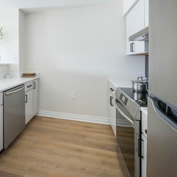 a kitchen with a sink, stove, and oven.
