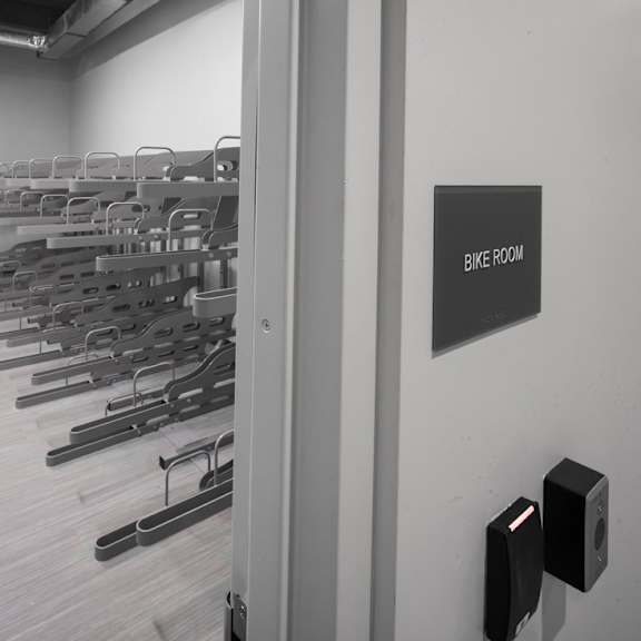 a bike room with a sign on the wall.
