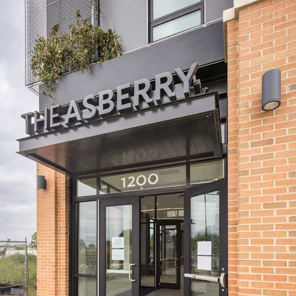 the entrance to the asberry building with a sign above the door.
