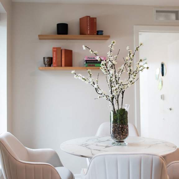 dining room table with decor on the wall above