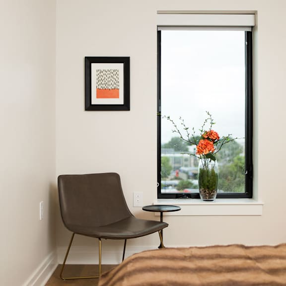 chair in a corner, next to a window