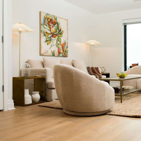 a living room with white furniture and a large window