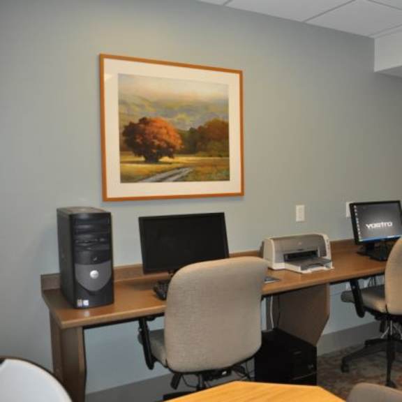 two computers sitting on desks in an office