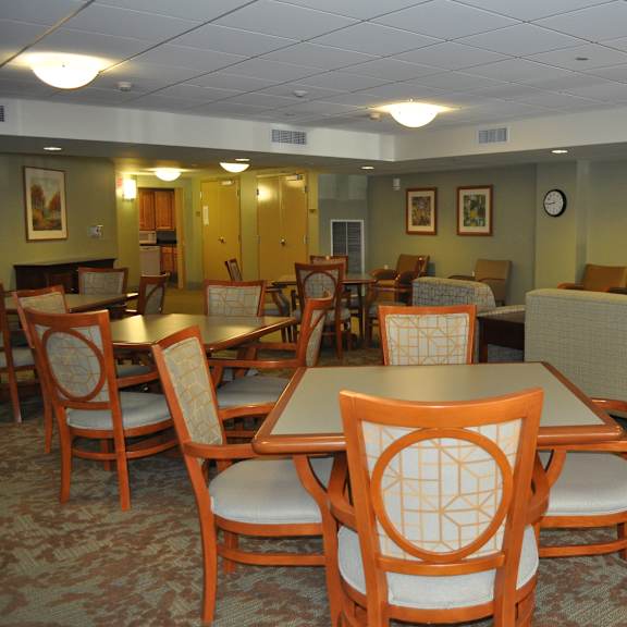 a dining room with tables and chairs and a tv