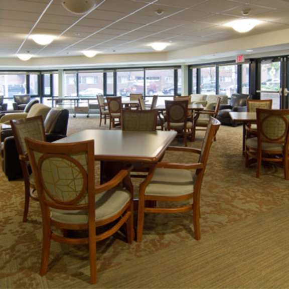 a large dining room with tables and chairs