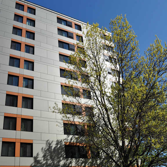 a tall building with a tree in front of it