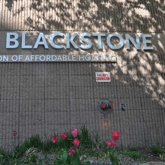 a sign for the blackstone preservation of affordable housing on the side of a building