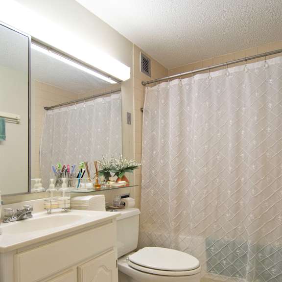 a bathroom with a toilet and a sink and a shower