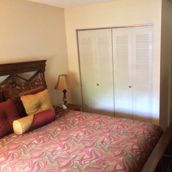 a bedroom with a large bed and a closet