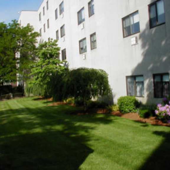 a large white building with a yard in front of it