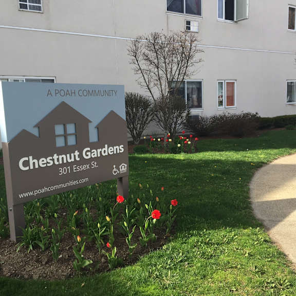 a sign for chesnut gardens in front of a building