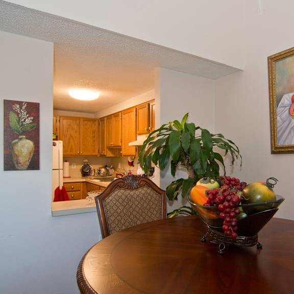 a dining room table with a bowl of fruit on it