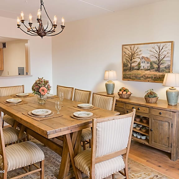a dining room with a wooden table and chairs.
