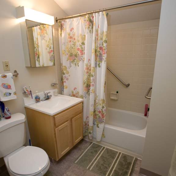 a bathroom with a toilet sink and tub and a shower curtain