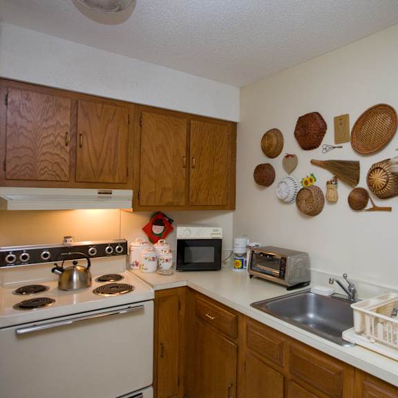 a kitchen with a stove top oven and a sink
