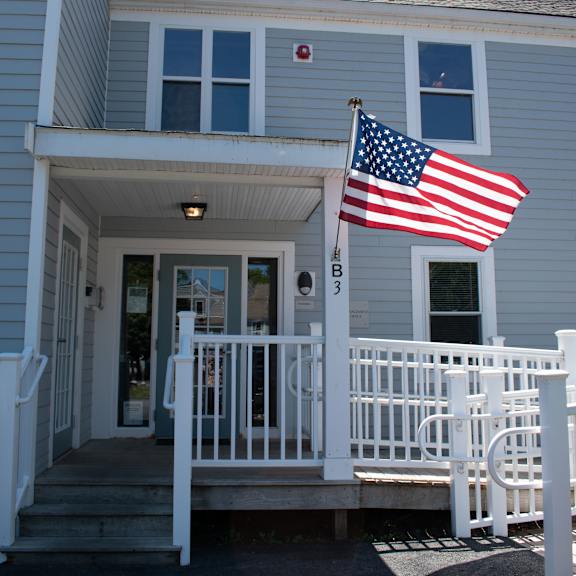 an flag flies in front of a house