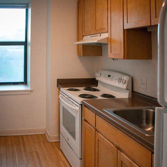 an empty kitchen with a stove and a sink