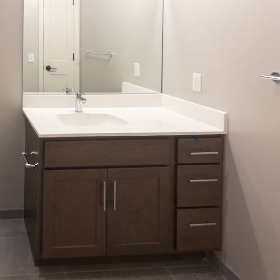 a white toilet sits next to a sink in a bathroom.
