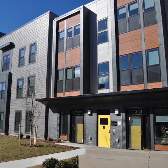 the exterior of a building with yellow doors