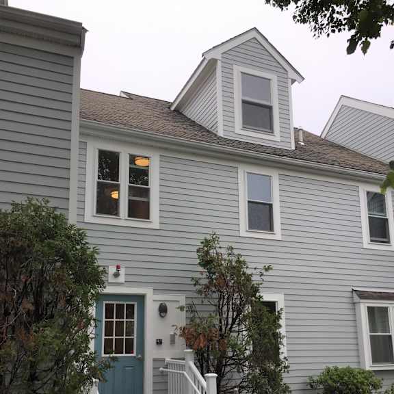 the front of the house with a blue door