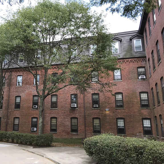 a red brick building with trees in front of it