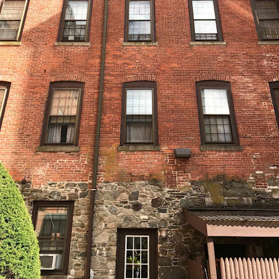 the side of a brick building with many windows