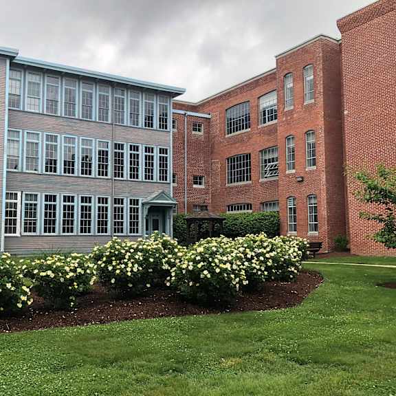a view of the front of a building with flowers
