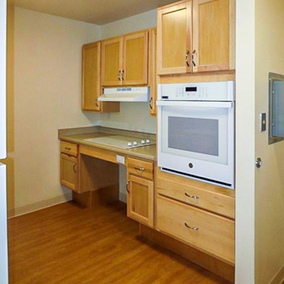 a kitchen with wooden cabinets and appliances.