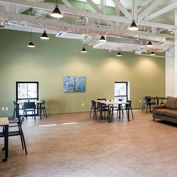 a room with couches and a table and chairs