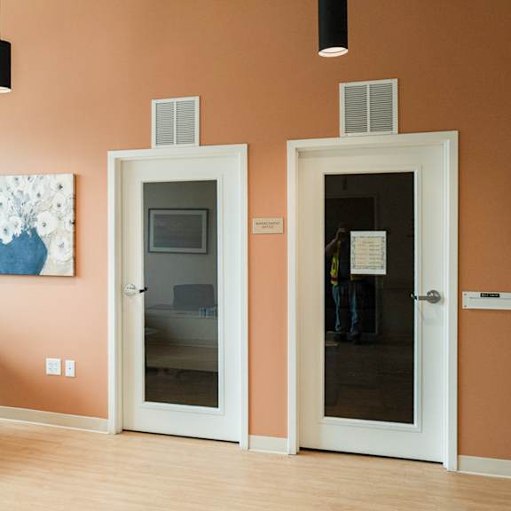 lobby with two doors and a chair