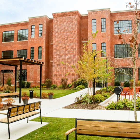 a red brick building with a walkway in front of it.