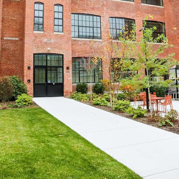 a red brick building with a black door and windows.