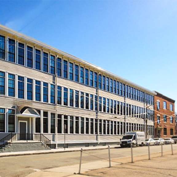 a large building with many windows and a white door.