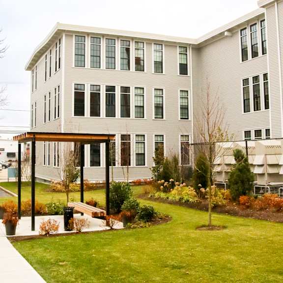 a modern building with a green lawn in front.