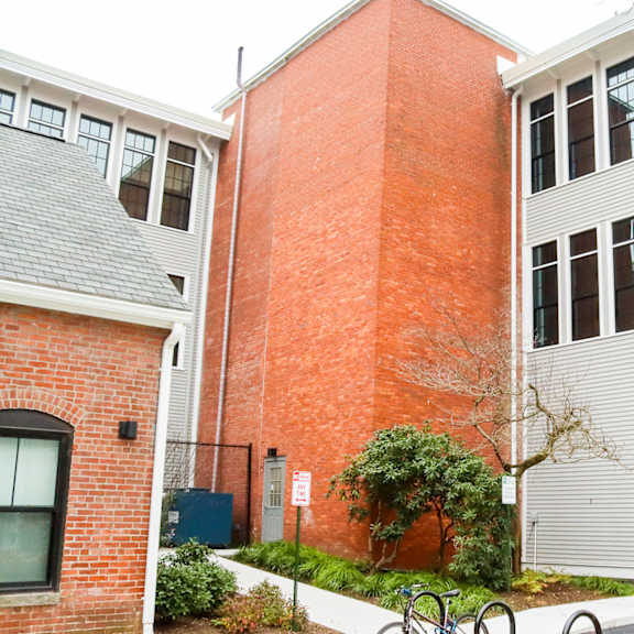 a red brick building with a white building next to it.