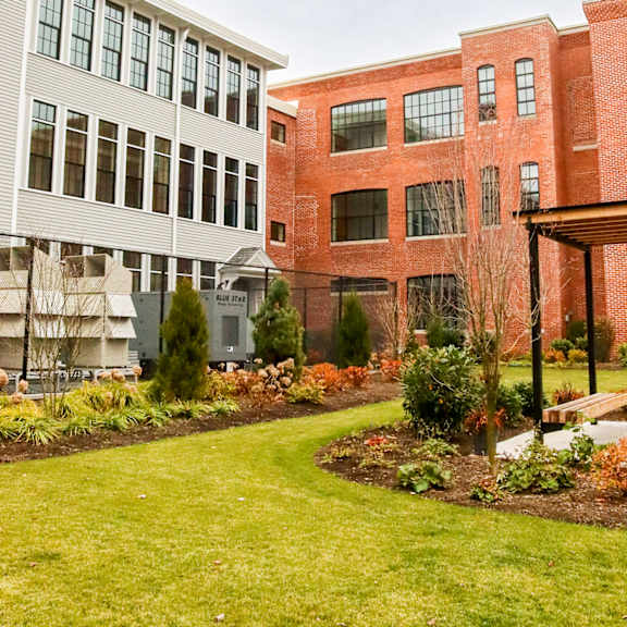 a red brick building with a white building next to it