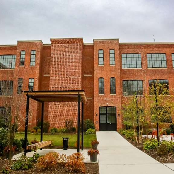 a red brick building with a black door and windows.