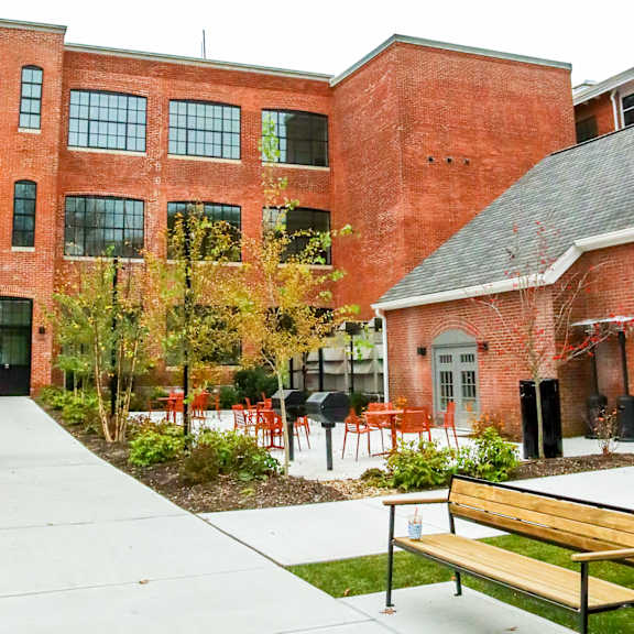 a red brick building with a bench in front of it.