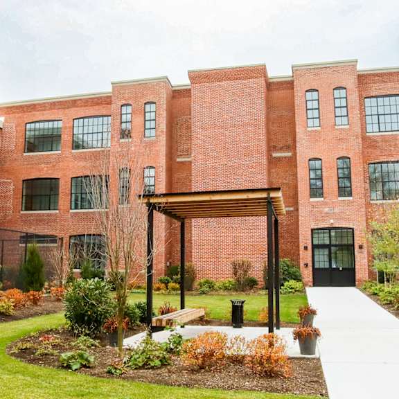 a red brick building with a walkway in front of it.